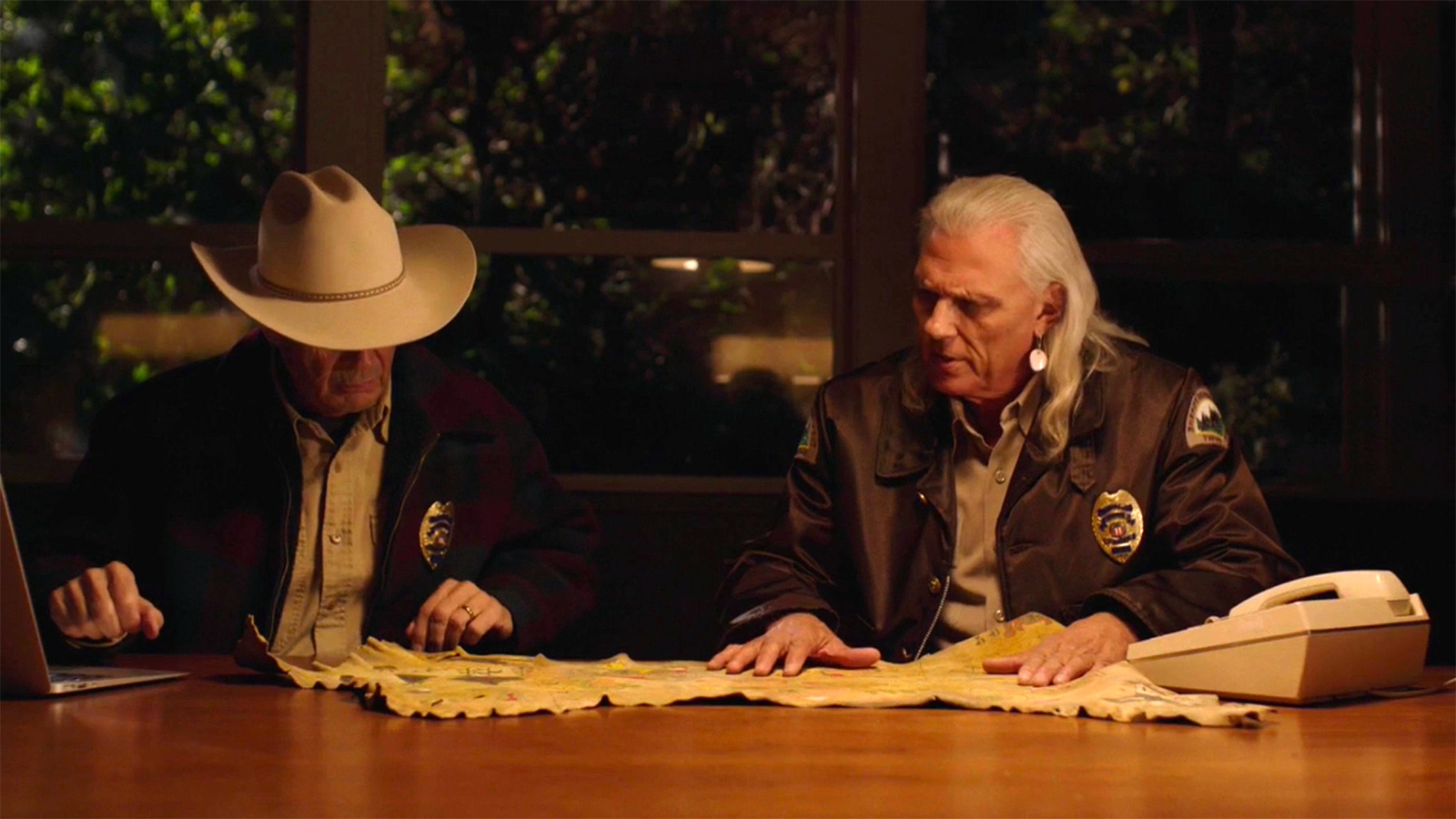 Screen grab from Twin Peaks showing Hawk and Truman looking at a map